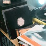 A cozy setup featuring vinyl records, a turntable, and a microphone for classic audio experience.